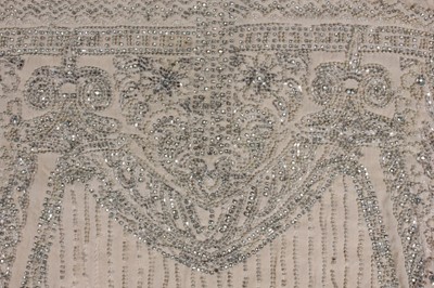 Lot 111 - A beaded ivory chiffon flapper dress, circa...