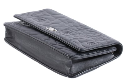 Lot 24 - A Chanel WOC of camellia-embossed black...