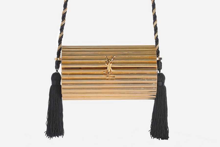 Lot 2 - An Yves Saint Laurent gilt resin cylindrical...