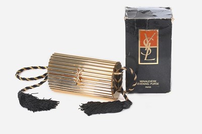 Lot 2 - An Yves Saint Laurent gilt resin cylindrical...