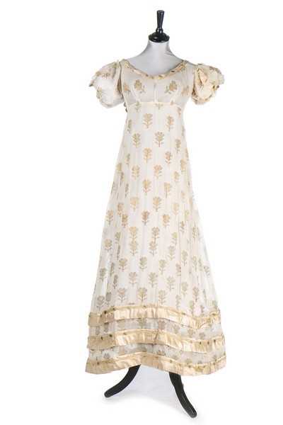 Lot 37 - A brocaded muslin evening dress, circa 1820,...