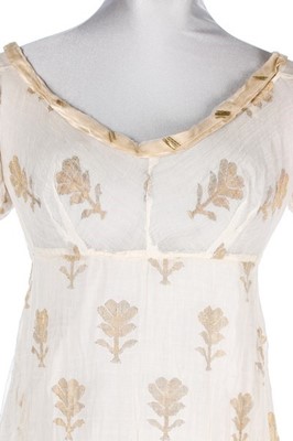 Lot 37 - A brocaded muslin evening dress, circa 1820,...