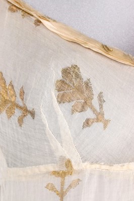 Lot 37 - A brocaded muslin evening dress, circa 1820,...