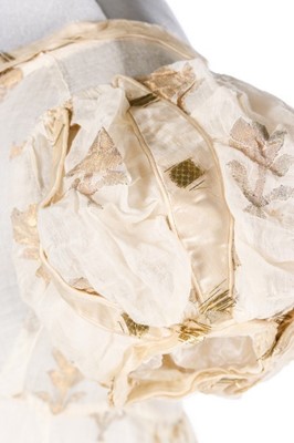 Lot 37 - A brocaded muslin evening dress, circa 1820,...
