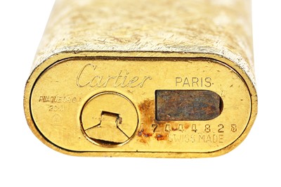 Lot 32 - A Cartier brushed-gold plated lighter, 20th century