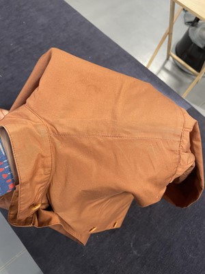 Lot 188 - An Issey Miyake two-piece ensemble in shades of brick-orange and black, circa 1977