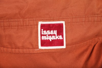 Lot 188 - An Issey Miyake two-piece ensemble in shades of brick-orange and black, circa 1977