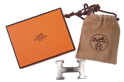 Lot 56 - An Hermès black leather belt with metal 'lock' clasp, modern