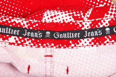 Lot 191 - A pair of Jean Paul Gaultier jeans printed with 'fight racism' and peace symbols, 2000s