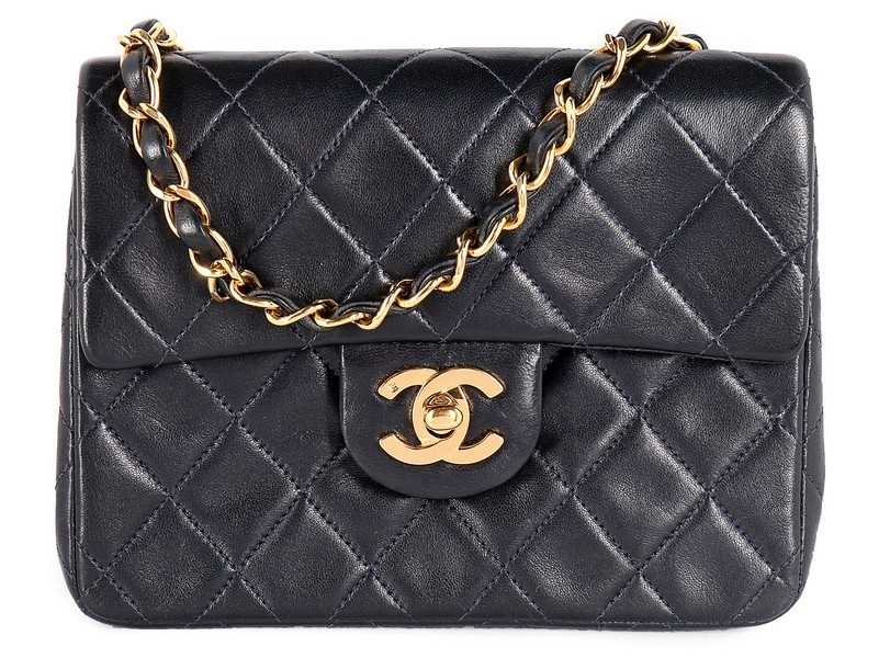 Lot 17 - A Chanel quilted navy leather bag, 1990s,...