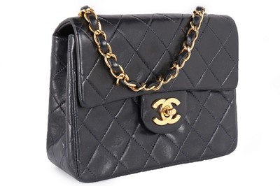 Lot 17 - A Chanel quilted navy leather bag, 1990s,...