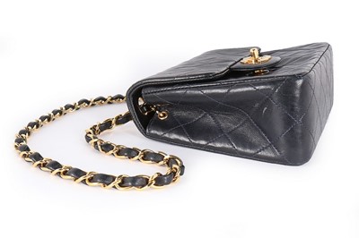 Lot 17 - A Chanel quilted navy leather bag, 1990s,...