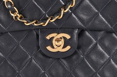 Lot 17 - A Chanel quilted navy leather bag, 1990s,...