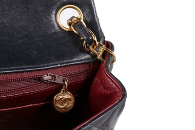 Lot 17 - A Chanel quilted navy leather bag, 1990s,...