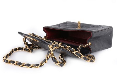 Lot 17 - A Chanel quilted navy leather bag, 1990s,...
