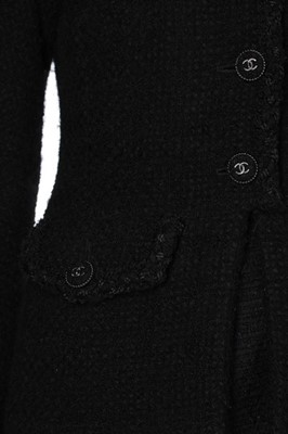 Lot 132 - A Chanel black bouclé wool dress and jacket...
