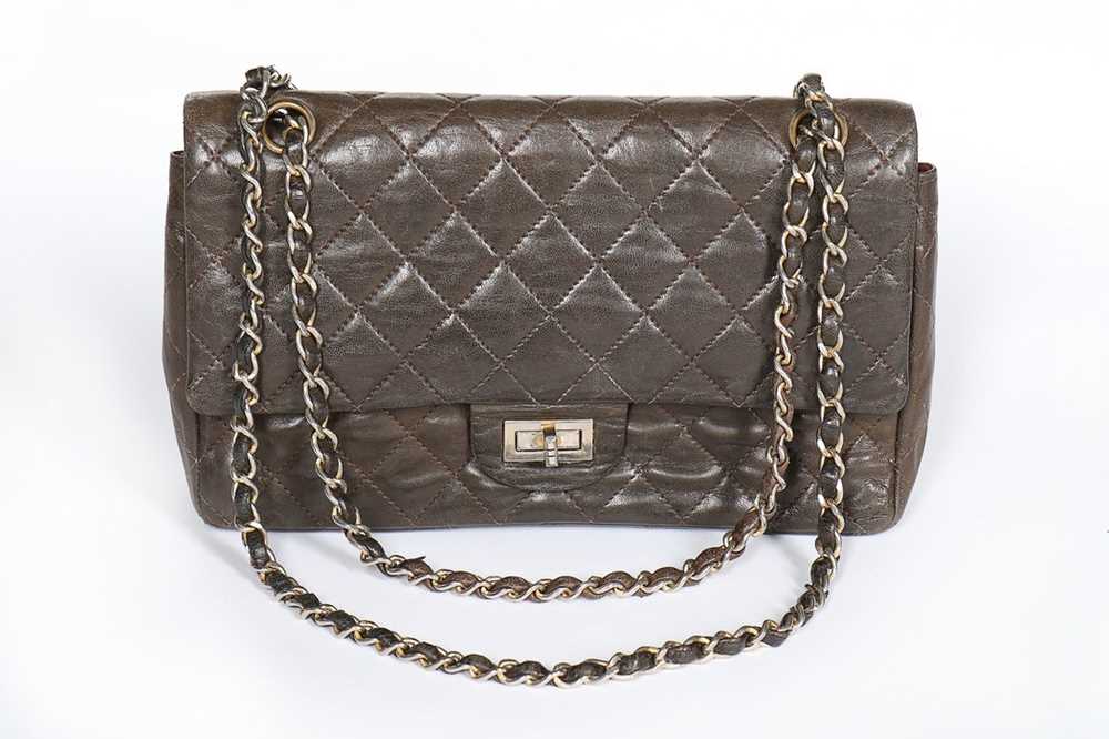 Lot 7 - A Chanel quilted brown leather flap bag, 1960s,...