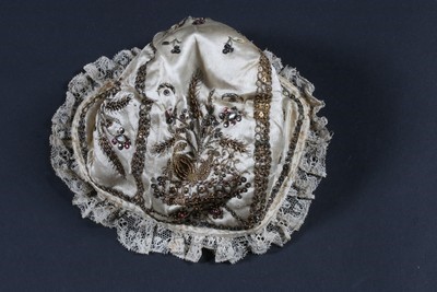 Lot 397 - An embroidered baby bonnet, Italian late 18th...