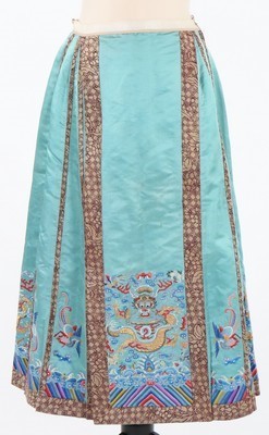 Lot 494 - An embroidered turquoise satin woman's skirt,...